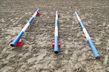 Image of an empty training field. Barriers for schooling horses as a background. Colorful photo of equestrian obstacles. Empty field for horse training event  clipart