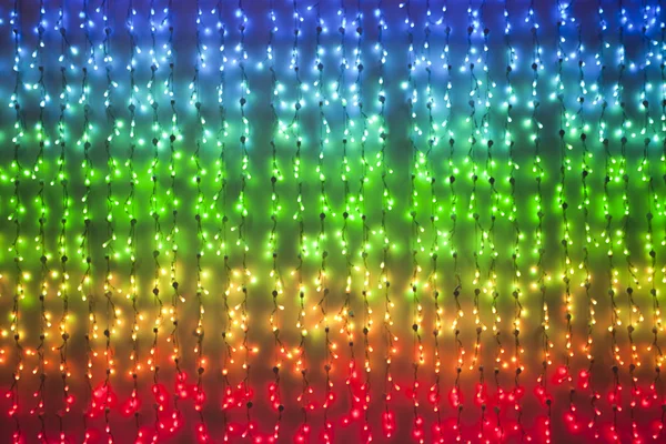 Kolorowe światła elektryczne x-mas na czarnym tle — Zdjęcie stockowe