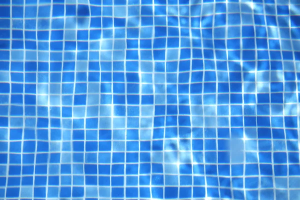 Sun reflected in the swimming pool water as a background — Stock Photo, Image