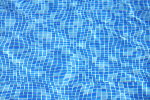 Sun reflected in the swimming pool water as a background — Stock Photo, Image