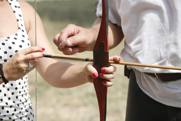 Unidentified pretty young girl hold bow and arrow — Stock Photo, Image