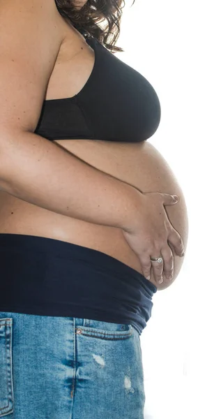 Беременная Женщина Смотрит Окно Трогает Живот — стоковое фото