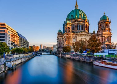 Güneşli Berlin Katedrali 'ni (Berliner Dom) gün batımında yansıması pürüzsüz Spree Nehri' nde bulanıklaşan güzel bir şekilde uzun süre yansıtır. Berlin, Almanya