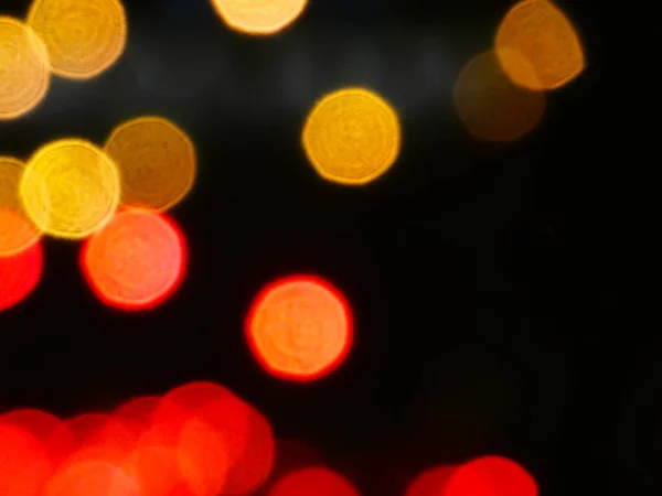 Red and yellow abstract lights with bokeh effect and in a dark background