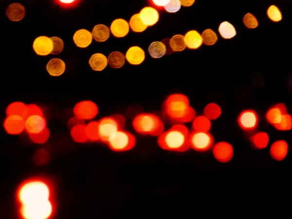 Track of yellow, grey and red lights in a black background