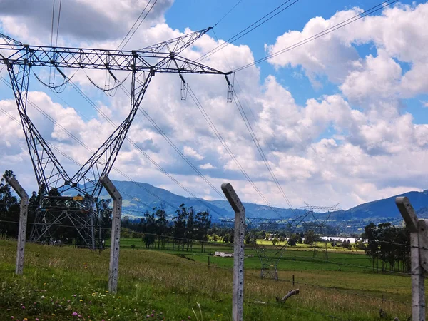 Huge electric towers installation along the fields of the countryside