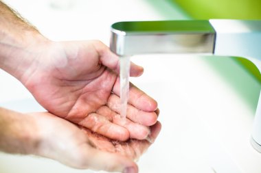 Washing hand under tap water clipart