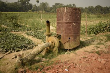 crude makeshift irrigation system for farmland at sohai village, west bengal, india clipart