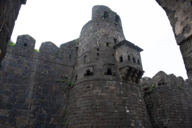 defensive tower at daulatabad fort with basalt stone walls and arched windows, maharashtra, india
