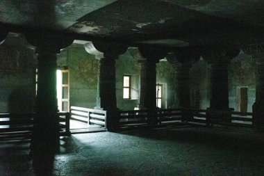Ajanta mağaraları, maharashtra, india- 30 Ağustos 2025: Adenta mağaralarındaki 1 numaralı mağaranın içi loş ışıklandırılmış, antik taş sütunlar ve keşiş hücrelerini gösteriyor.