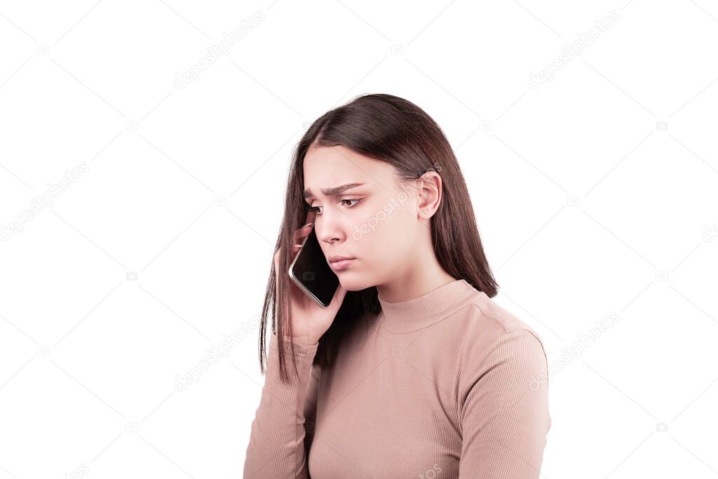 pretty young girl talking on phone sad