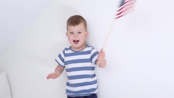 Little child boy in striped t-shirt waving American flag. usa Independence Day concept. — Video Stock