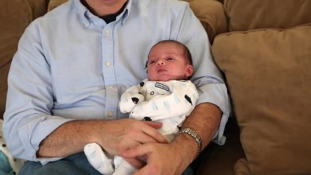 Grandfather holding his newborn grandson — Stock Video