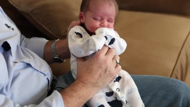 Grandfather holding his newborn grandson — Stock Video