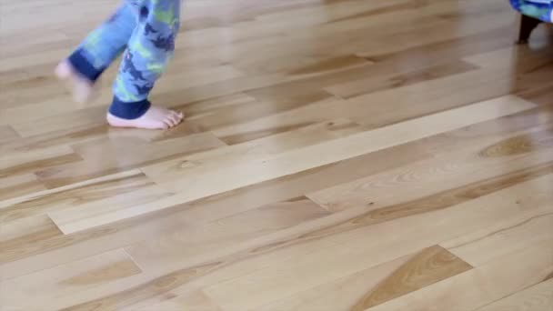 Boy twirls on a wood floor — Stock Video