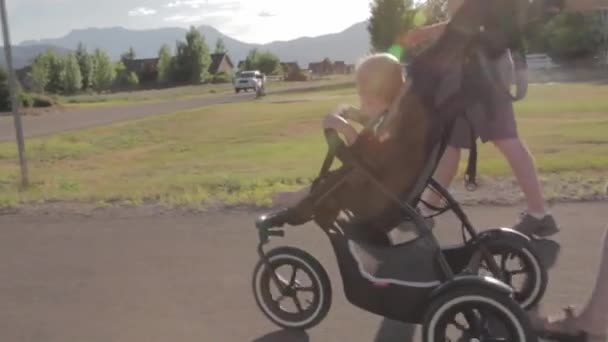 Kvinna som driver baby i en barnvagn — Stockvideo