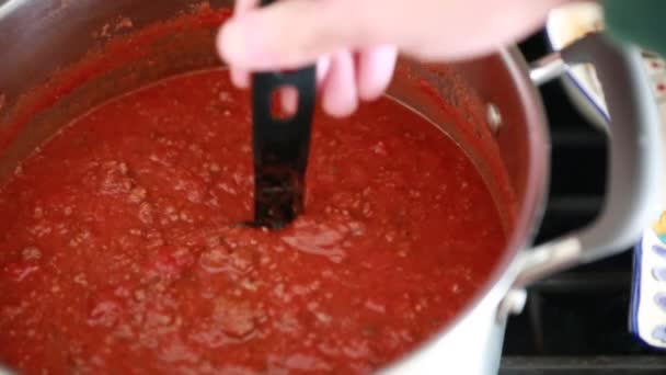 Man stirs spaghetti sauce — Stock Video