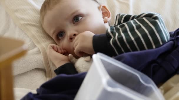 Boy with the flu lying on the floor — Stock Video