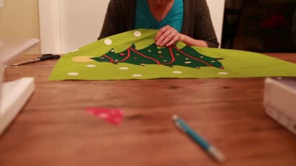 Женщина, шьющая рождественский календарь — стоковое видео