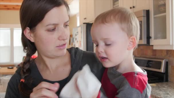 A toddler blows nose into kleenex — Stock Video