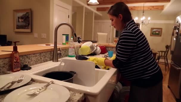 Una mujer embarazada lavando platos — Vídeos de Stock