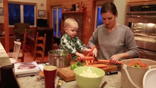 Criança ajudando sua mãe cozinhar — Vídeo de Stock