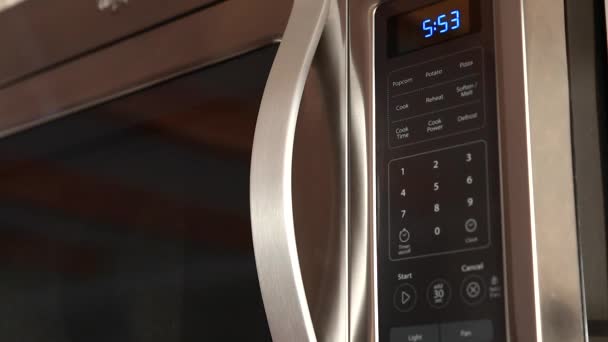 Woman pushing buttons on the microwave — Stock Video