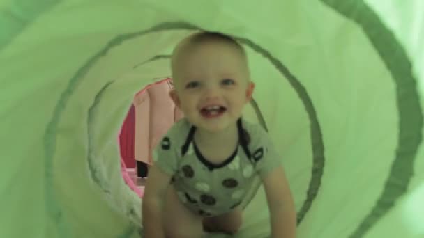 Een jongen speelt met een tunnel — Stockvideo