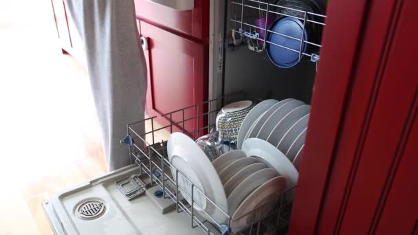 Woman unloads the dishwasher — Stock Video