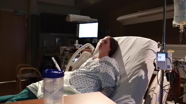 Woman on bed with an iv — Stock Video