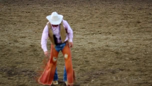 Cowboy coxeia através da arena — Vídeo de Stock