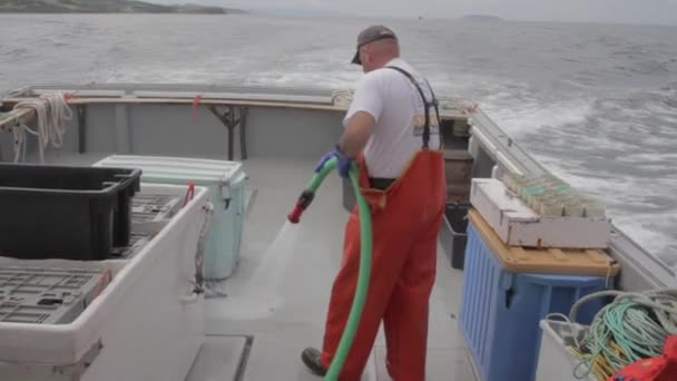 Pescador limpiando su barco — Vídeo de stock