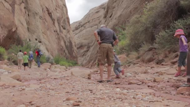 Family hiking through a canyon — Stock Video