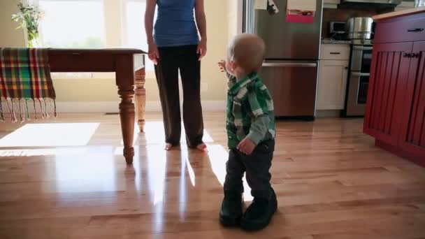Boy walking in his fathers shoes — Stock Video