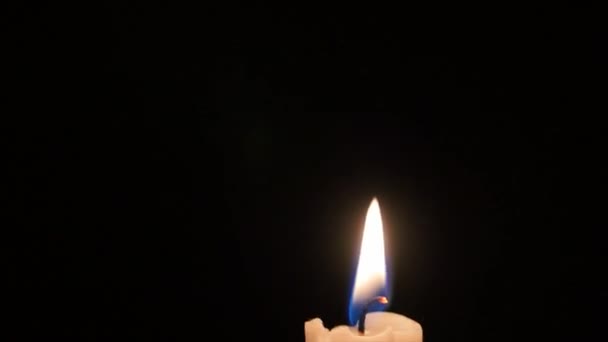 Lit candle in the dark room Stock Video