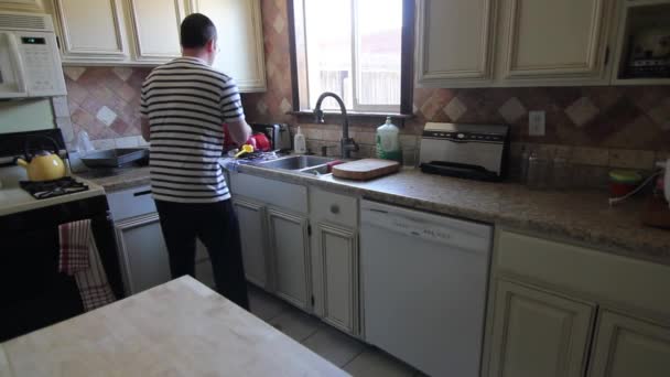 Hombre limpia cocina — Vídeos de Stock