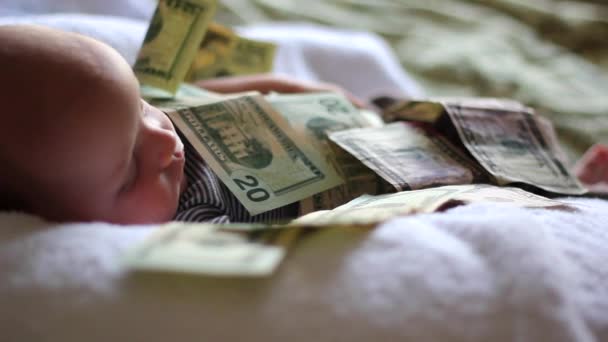 Bambino sdraiato in un mucchio di soldi — Video Stock