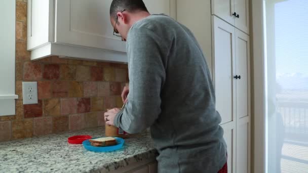 Man licks off peanut butter — Stock Video