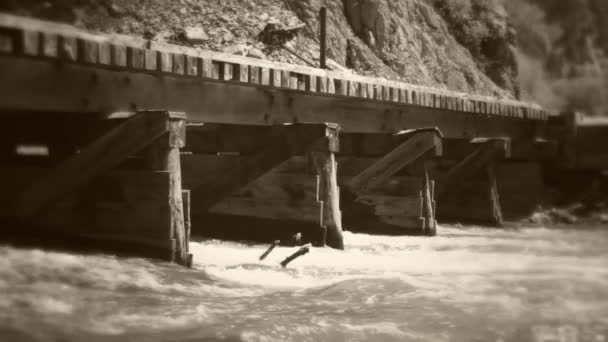 Old train bridge over flooding river — Stock Video