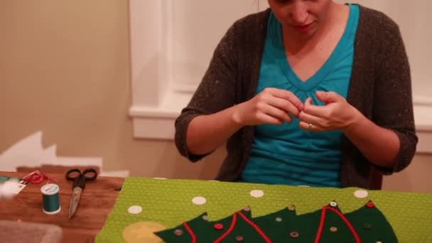 Woman sews an advent calendar — Stock Video