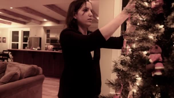 Woman decorates christmas tree — Stock Video