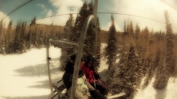 Pair on the ski chair lift — Stock Video