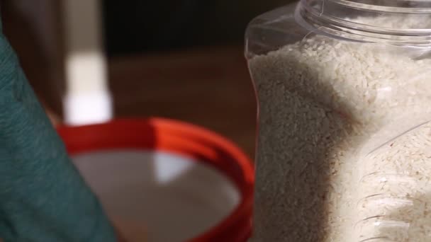 Woman filling food container with rice — Stock Video