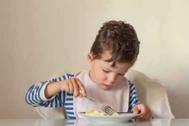 Baby eats top view kitchen Breakfast copyspace.