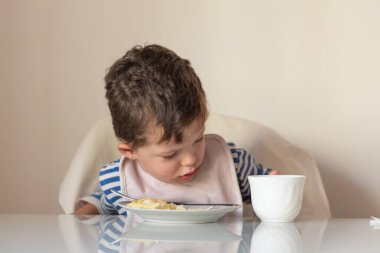 Baby eats top view kitchen Breakfast copyspace.