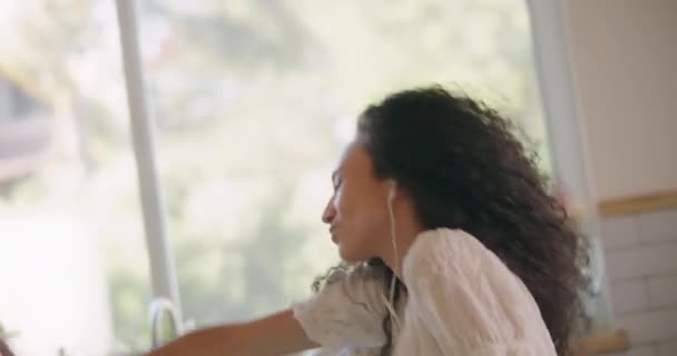 Young happy girl dancing alone in the kitchen — Stock Video