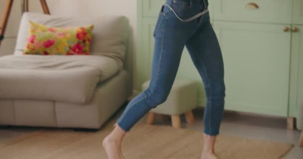 Woman dances at home with arms raised up — Stock Video