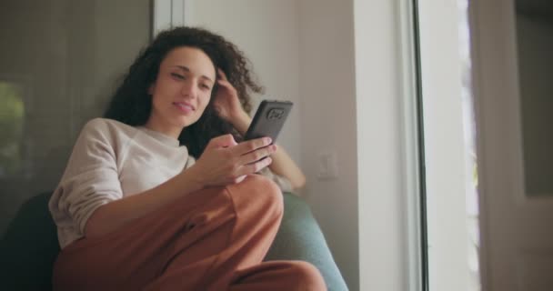 Femme regardant avec intérêt son téléphone — Video