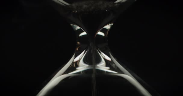 Macro shot of sand pouring in hourglass — Stock Video