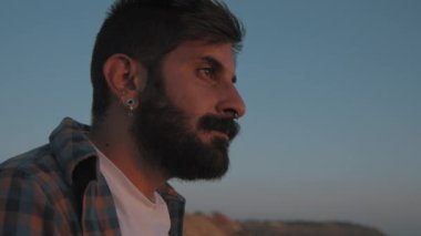 A mixed race man looking at sunset